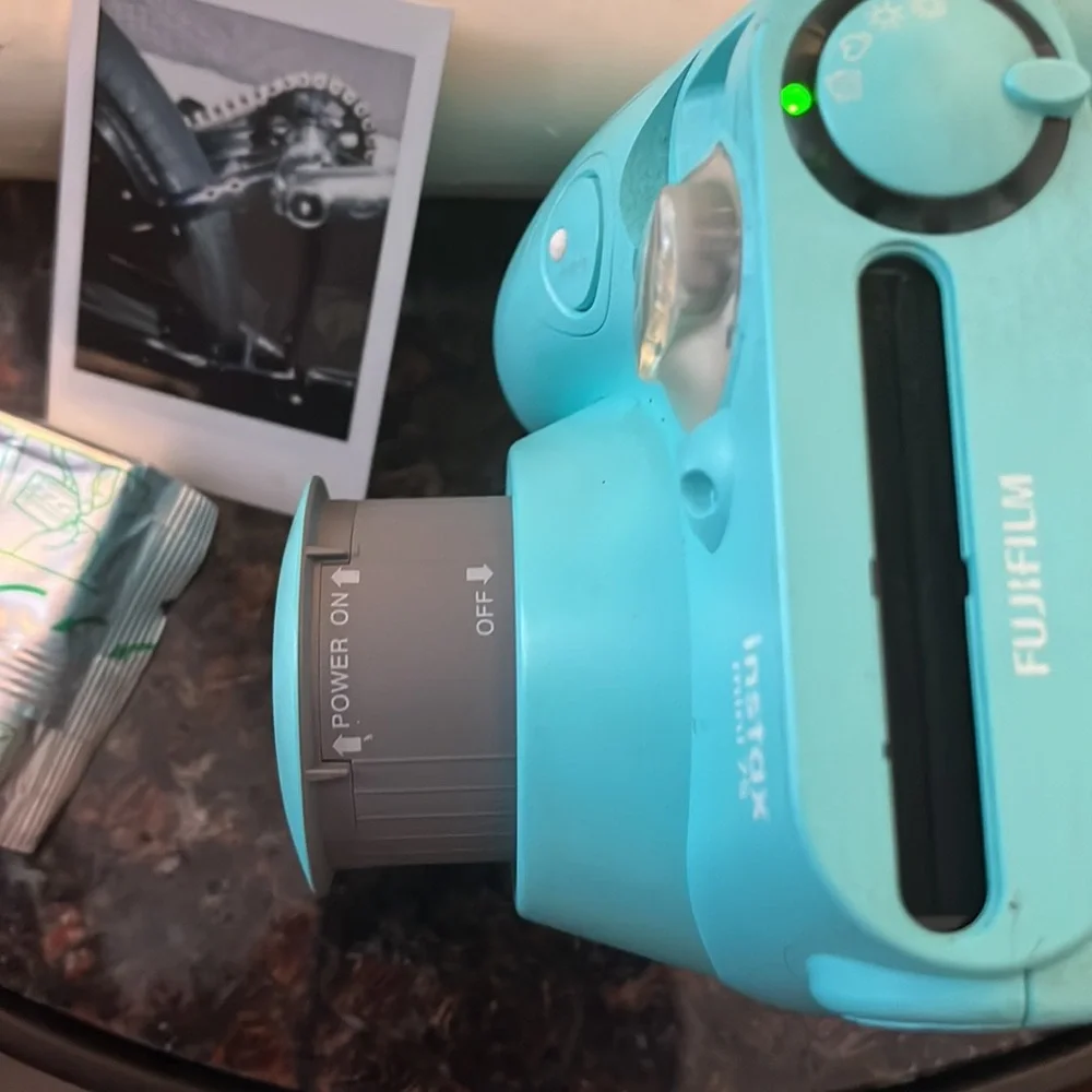 Polaroid camera made by Fujifilm called the Instax mini 7s